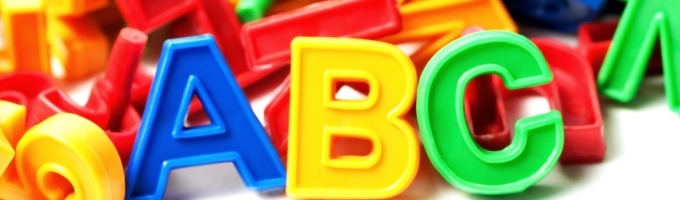 farverige plastikbogstaver i en bunke med a, b og c stående i forgrunden